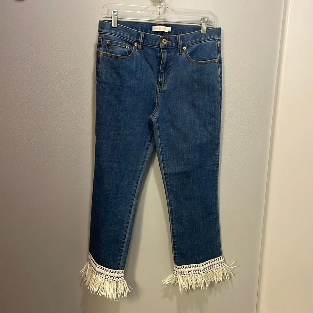 Tory Burch Connor jeans in medium allover stone wash. Cropped. Raffia fringed